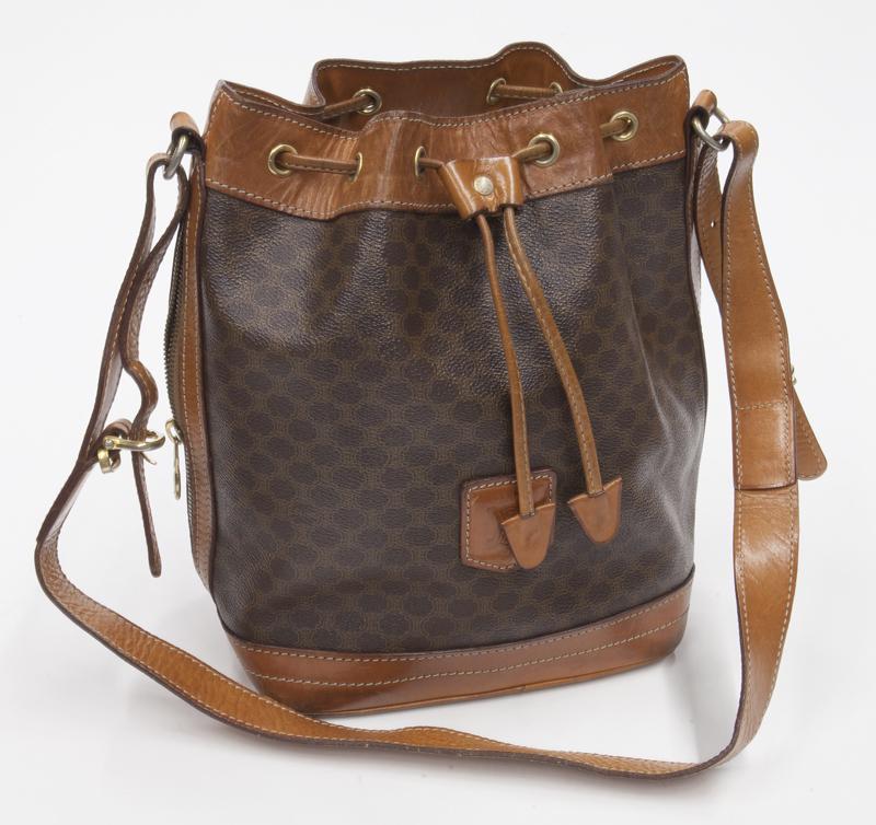 Celine Drawstring Tote Shoulder Bag: Celine Drawstring Tote Shoulder Bag in brown Macadam coated canvas with brown leather handles and gold hardware, marked: M90. 7.75 x 10.5 x 5".