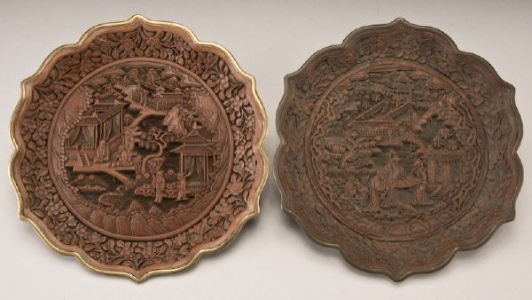 (2) Chinese Qing dynasty cinnabar plates,: each depicting figures in a landscape. Both with six character Qianlong marks. 9.25" Dia., Circa - 19th C.