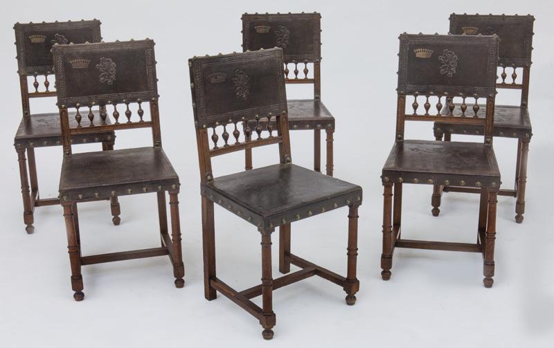 (6) Italian Renaissance-style side chairs,: the rectangular leather seat back over turned spindles atop trapezoidal seat supported by turned legs and stretcher, leather back and seat with tooled border and central rampant lion. PROVENANCE: From