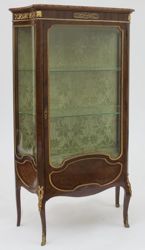 Louis XV style vitrine,: the beveled glass front and concave sides over base with geometric inlay raised on cabriole legs with ormolu floral and acanthine mounts. With two glass shelves to interior. Electrified. 67.5"H x 36.5