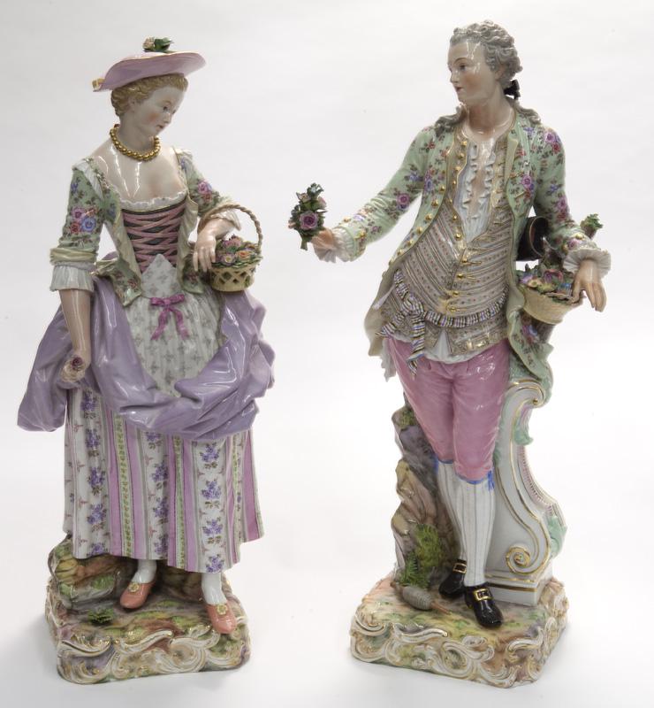 Pr. Large Meissen porcelain Gardeners,: depicting a gentleman and lady with floral baskets, raised on scrolling bases. Each with cross swords mark in blue underglaze. 20"H, Circa - 19th C.