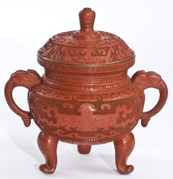 Chinese carved cinnabar lacquer tripod censer: depicting faces of the beast. Provenance: The collection of Derrill Osborn. 20"H x 22"W x 12" Dia., Circa - 20th C.