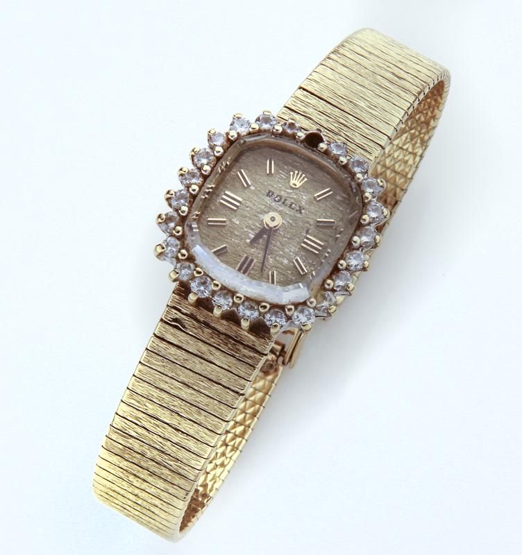 Rolex 14K gold & diamond ladies wristwatch.: Rolex 14K gold & diamond ladies wristwatch. Case and clasp stamped, "14K Gold". Approx. .25 ct. diamonds prong set surrounding bezel. Not in working order. 26.0 grams. 6.25"L,