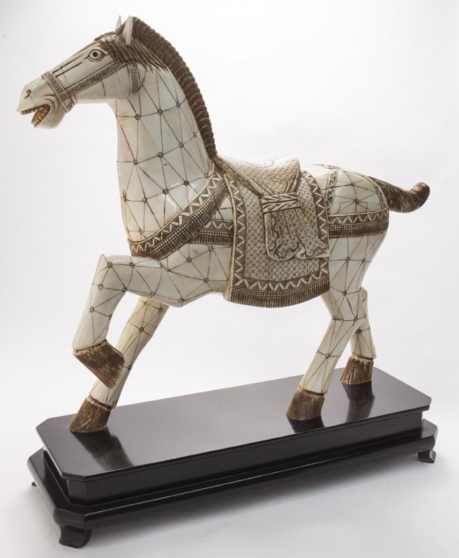 Asian style bone tile clad model of a rampant: Asian style bone tile clad model of a rampant horse with etched geometric designs throughout. Raised on canted corner black lacquer base. Horse: 23"H x 6"W x 26"L; Overall: 27"H x 9.5"W x 25"L. Circa 