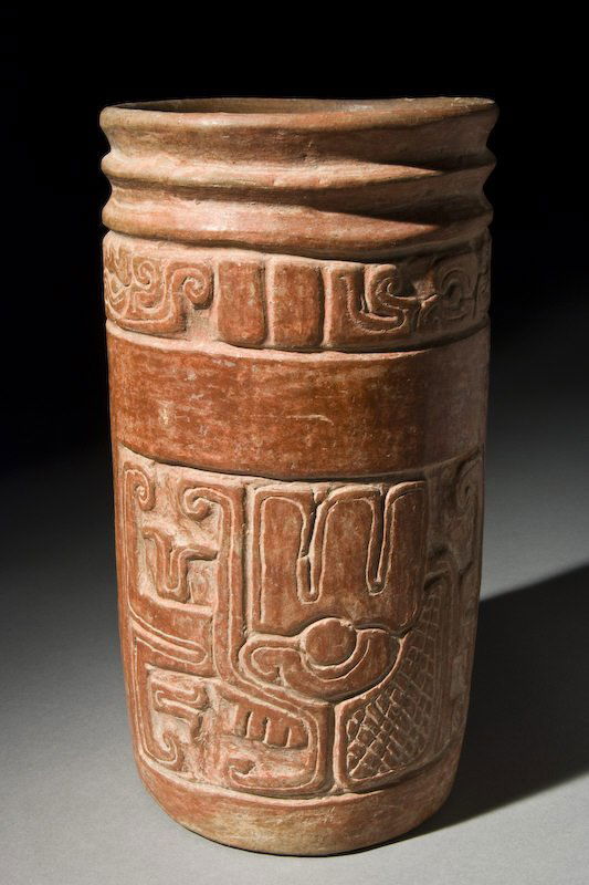 Pre-Columbian Mayan Postclassic redware vase with: Pre-Columbian Mayan Postclassic redware vase with carved relief primary glyph band above two opposed glyph panels. El Salvador. Intact, mineral deposits, rare for type. 9.125"H, Circa - 1000 A.D.