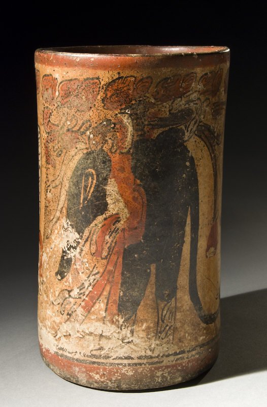 Important Classic Mayan cylinder vase with primary: Important Classic Mayan cylinder vase with primary glyph sequence and rollout of coatimundi and vertical glyph bands. Peten. Intact with minor erosion near base. 7.375"H, Circa - 550-750 A.D.