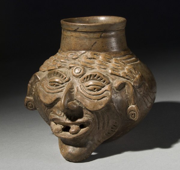 Important Mayan fired plumbate head pot depicting,: Important Mayan fired plumbate head pot depicting, "Fire" god old man; fine reduced, rendered by Mayan artists of the period. Intact and choice, mineral deposits, base worn. 6"H x 6.5"W, Circa - 1000 