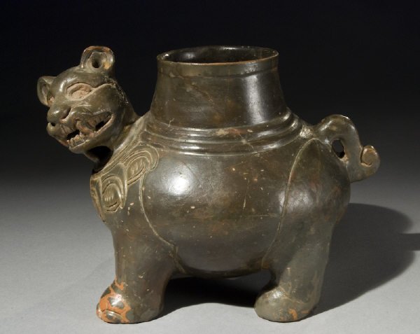 Postclassic Mayan fine jaguar effigy reduced fired: Postclassic Mayan fine jaguar effigy reduced fired plumbate vessel. El Salvador. Stress cracks in lip area filled, choice and unique example. 6.125"H x 8"W, Circa - 1000 A.D.
