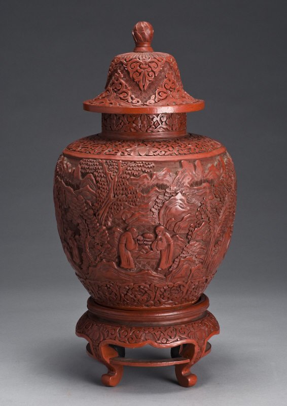 Chinese Qing carved cinnabar ginger jar with origi: Chinese Qing carved cinnabar ginger jar with original cinnabar stand carved to depict figures in a landscape; without stand: 13.5"H. With stand: 17.5"H, Circa - 19th C.