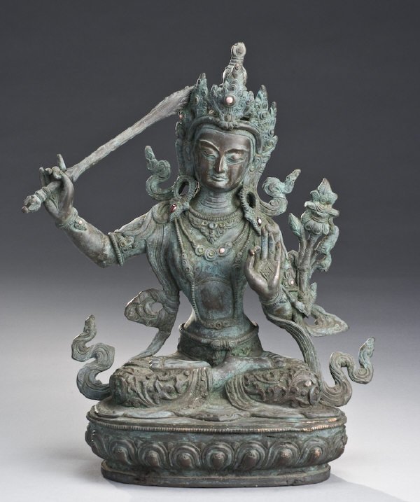 Qing Chinese Tibetan bronze Buddah posed with his : Qing Chinese Tibetan bronze Buddah posed with his right hand holding a sword, his left hand in Buddhist Mudra, seated on a throne. 11.75"H, Circa - 19th C.
