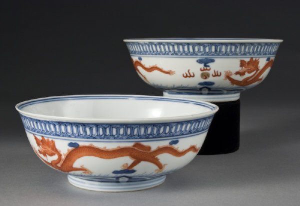 Pr. Chinese blue and white with iron red porcelain: Pr. Chinese blue and white with iron red porcelain bowls finely painted to depict dragons in clouds. Spurious six character Qianlong mark. 2.75"H x 6.75" Dia., Circa - 19th C.