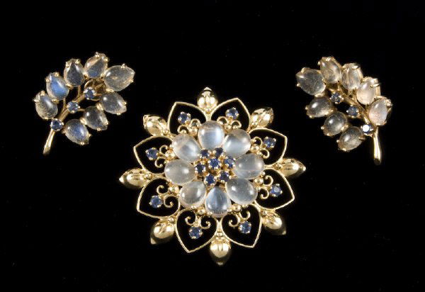 Retro 14K, sapphire and moonstone brooch and ear-: Retro 14K, sapphire and moonstone brooch and ear- rings, mounted with 24 pear shaped cabochon cut moonstones and accented with 21 round brilliant cut sapphires, 1.68 cts. approximate total. Earrings w