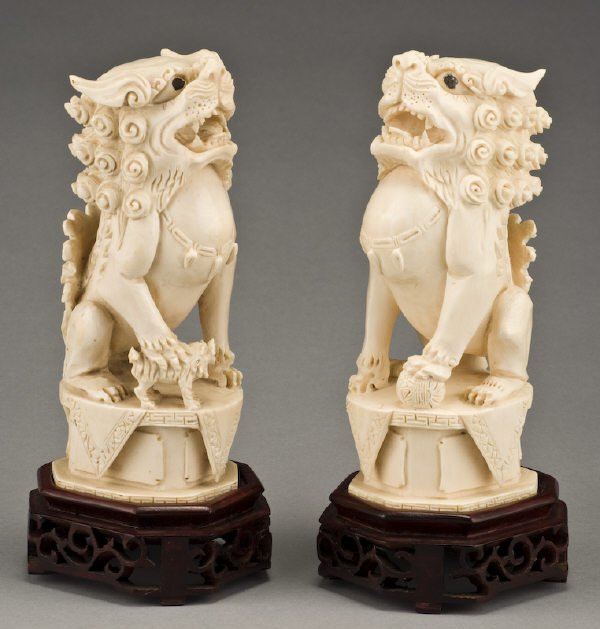 Pr. Chinese ivory foo dogs raised on a rosewood (I: Pr. Chinese ivory foo dogs raised on a rosewood (International shipping IS NOT available on this item. This elephant ivory was imported legally into the United States.) stands. With stand: 8.75"H x 3.