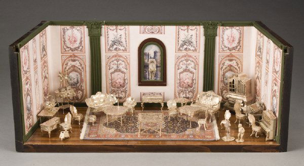 30 Pc.. Miniature silver furniture in a diorama: of an elegant parlor with paneling hardwood floors, wallpaper and an oriental carpet, the silver bearing English, European and American hallmarks and including intricately embossed silver in forms suc