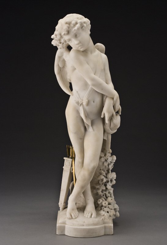 Italian Carrera marble sculpture signed,: "C. Balloni", modeled as cupid with gilt bronze bow and arrows. Signed on the base, "C. Balloni". 25.5"H, Circa - Second half 19th C.