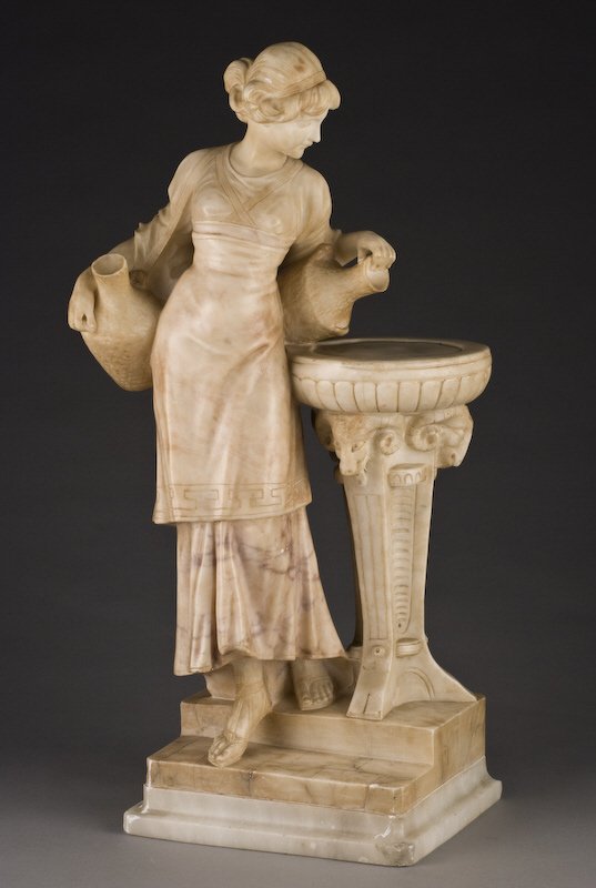 Italian alabaster sculpture signed, "A. Giorgi": carved to depict a young maiden pouring water into a well with a tripod base decorated with ram's head. 24"H Circa - Late 19th C.