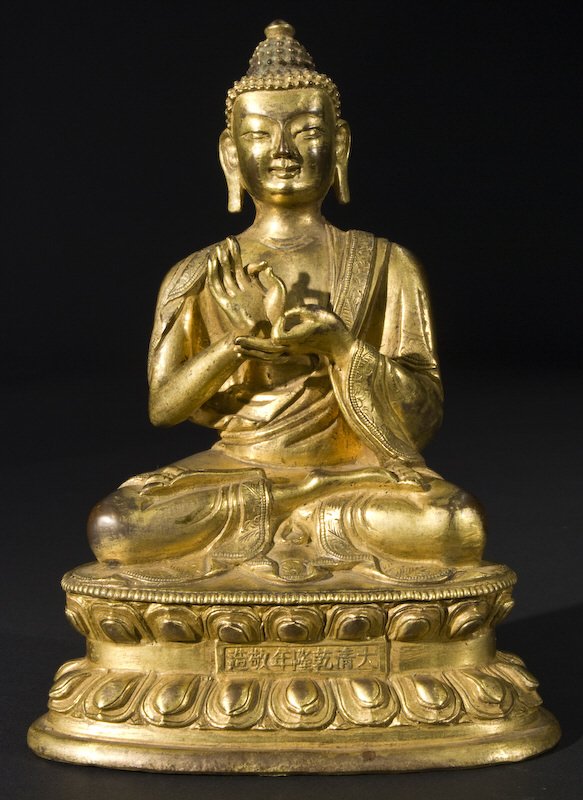 Chinese Qing Qianlong gilt bronze Buddha seated on: a lotus base, with hands in Buddhist mudra. Marked for Great Qing Qianlong production. 6.25"H, Circa - 1735-1795.