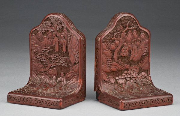 Chinese Qing carved cinnabar bookends depicting: figures in a landscape. 6.25"H x 4.25"W x 3.5"D, Circa - 19th C.