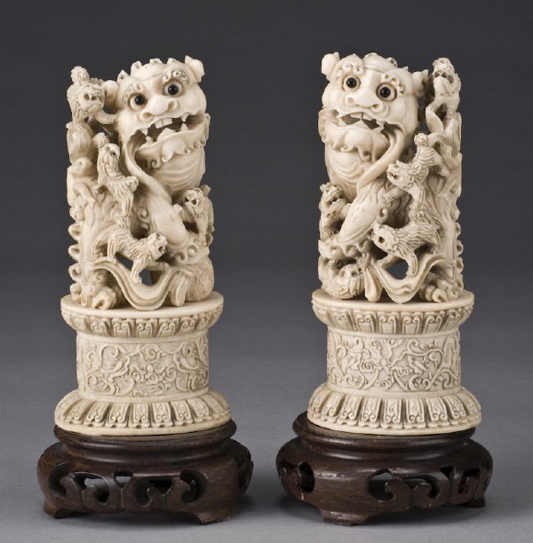 Pr. Ivory foo dogs raised on hardwood stands.: (International shipping IS NOT available on this item. This elephant ivory was imported legally into the United States.) Without stand: 6"H, Circa - 20th C.