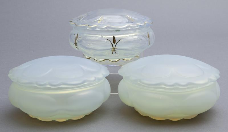 (3) French glass lidded powder bowls,: (3) French glass lidded powder bowls, (2) opalescent and (1) with gilt accents. Unmarked. Attributed to Sabino. 2.25"H x 4.625"D,