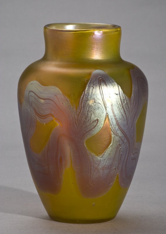 Loetz Phanomen Genre 29 glass vase: having an ovoid shoulder form with a cylindrical neck on a gold iridescent ground with a pulled silvery-iridescent decor. Unmarked. Provenance: By descent: Francis Townsend Underhill (1863-1929) partn