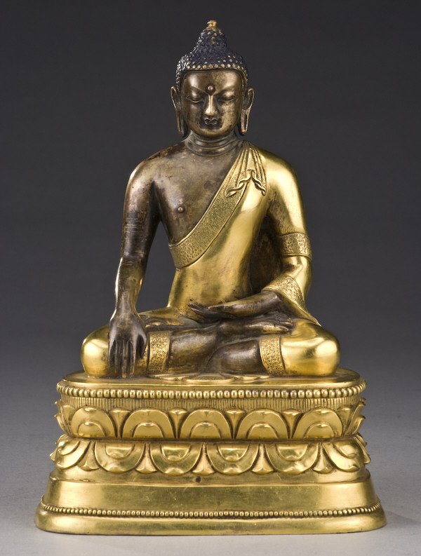 Chinese - Tibetan gilt bronze Shakyamuni Buddha: seated on a lotus throne, hands in Buddhist mudra. 9"H, Circa - 20th C.