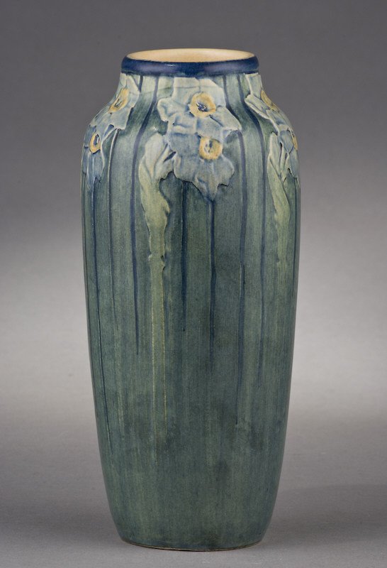 Newcomb College pottery vase decorated by Sadie: Irvine with low relief carved jonquil design with a semi-matte glaze, potted by Joseph Fortune Meyer. 8"H, Circa - 1912.