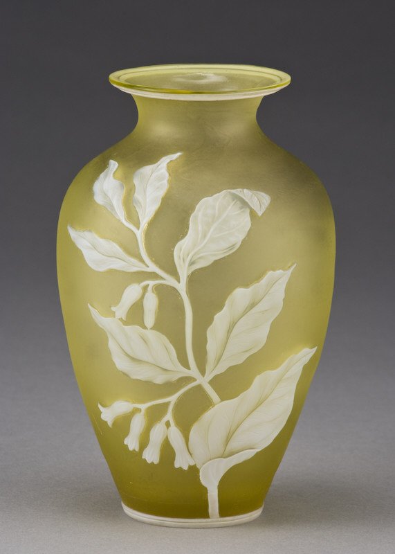 Thomas Webb cameo glass vase: of ovoid form with a flared rim of citrine glass overlaid with a cameo cut white floral spray with a butterfly to the reverse and double bands to either end. Base signed, "Thomas Webb and Sons". Prove