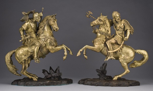 Pr. Gilt bronze warriors on horseback: depicting a Crusader and a Saracen both in full battle attire on armored horses, each on a rocky outcropping, unmarked. 20.5"H, Circa - Late 19th C.