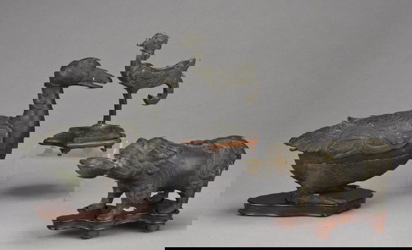 (3) Chinese Ming bronze figures including: (1) duck box; (1) foo-dog oil lamp; (1) phoenix with eight characters on the underside. Largest, without stand: 6.5"H, Circa - 16th - 17th C.