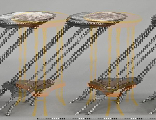 Pr. Louis XVI style gueridons in the manner of: Adam Weisweiler, with circular inset marble tops, legs draped with swirled floral garlands joined by a wooden shaped stretcher on hoofed feet. 28.5"H x 18" Dia., Circa - First half 20th C.