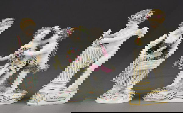 (3) Meissen porcelain figures including: (1) modeled as a young girl holding a basket of fruit; (1) modeled as two putti holding floral wreaths; (1) modeled as a cherub entitled, "Je les unis". All with cross swords mark in blue under glaze,