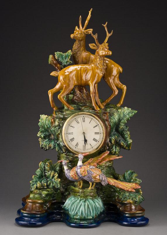 Impressive German Majolica mantle clock,: the clock dial surmounted by a pair of stags with two roosting pheasants below resting on an undulating naturalistically modeled base. Clock has been replaced with a contemporary battery operated move