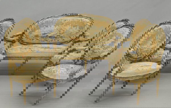 5 Pc. Louis XVI style gilt wood salon set: consisting of a settee and four armchairs having oval backs and knots at apex, with egg and dart and acanthus molding, on tapering fluted legs, the backs, seats and arm pads upholstered with Aubusson