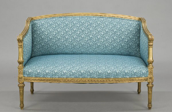 French Louis XVI style gilt wood canape: ornately carved with acanthus, scrolls and interlaced rosettes, on tapered fluted legs on toupe feet. See pair of bergere chairs in suite, lot number 176. 34"H x 49"W x 25"D, Circa - Late 19th C.