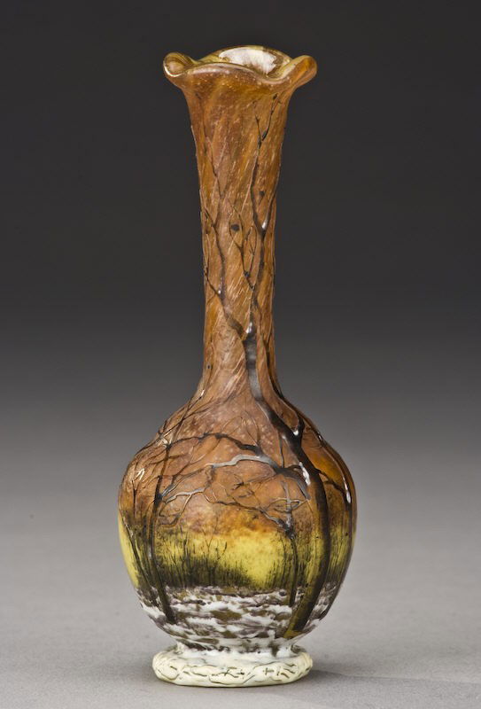 Daum Nancy Winter scene French cameo vase,: bulbous stick form in a rich mottled orange decorated with bare winter trees on a snow covered meadow silhouetted against a lemon yellow sky, signed, "Daum Nancy". Literature: for vases with similar d