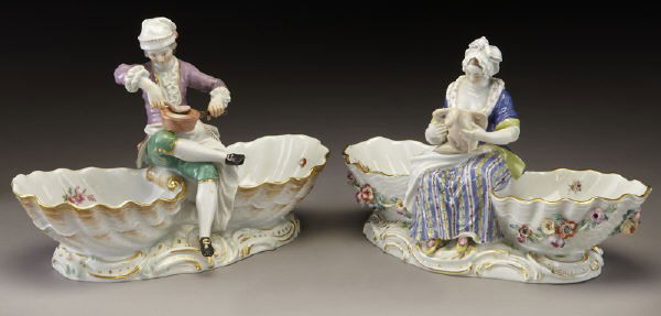 Pr. Meissen porcelain figural sweetmeat dishes: Pr. Meissen porcelain figural sweetmeat dishes modeled as a male and female preparing a feast between two shell shaped dishes. Cross swords mark in blue under glaze, incised, impressed, and painted nu