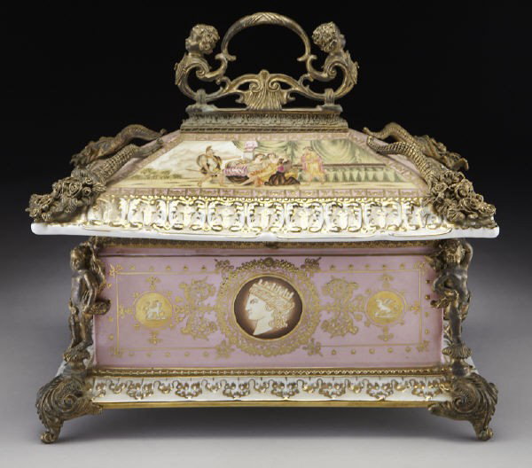 Vienna style bronze and porcelain jewel casket: Vienna style bronze and porcelain jewel casket the rectangular casket surmounted by a cherub-form handle, the hinged cover adorned with cast cornucopia to the corners, the body with a pink ground and 