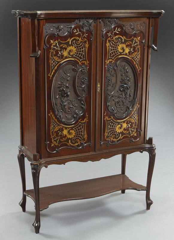 Edwardian mahogany cabinet,: Edwardian mahogany cabinet, the doors with inlaid brass and satinwood decoration surrounding floral panels carved in high relief, the doors open to three shelves; raised on cabriole legs joined by a l