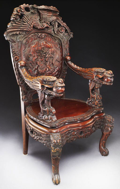 Japanese carved high back armchair,: Japanese carved high back armchair, the crest depicting a deeply carved Ho-Ho bird over a back centered by a Shi-Shi within a cloud surround and continuing into low arms carved as dragons with pearls