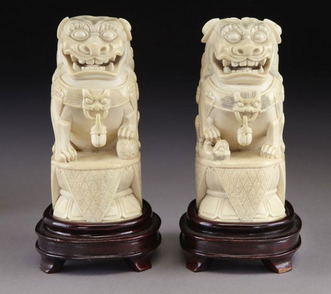 Pr. Chinese carved ivory foo dogs raised on wood (I Mar 16, 2011