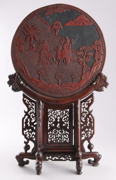 Chinese late Ming carved cinnabar table screen dep: Chinese late Ming carved cinnabar table screen depicting the God and Goddess of Longevity. Six character Xuande mark. Screen: 15.5" Dia., Overall: 28.25"H, Circa - 16th - 17th C.