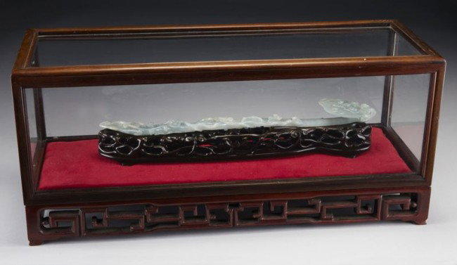 Chinese Qing carved jadeite ruyi scepter, finely c: Chinese Qing carved jadeite ruyi scepter, finely carved in Lingzhi shape (15.5"L), set in a carved rosewood box (9.75"H x 21.5"W x 7.75"D). Circa - 19th C.