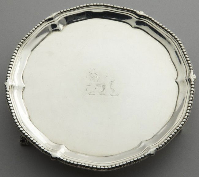 George III sterling silver waiter by John Carter: with a beaded scalloped rim centering a lion crest; raised on claw and ball feet. Marked for John Carter, London 1774. 6.78 ozt. Provenance: Collection of Kate and Jack Wheeler, Salado, Texas. 6.25" D