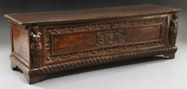 17th C. Italian carved walnut cassone: of six board construction, the lid with cotter pin hinges, the front floral carved panel flanked by figural pilasters, the whole standing on bracket feet. Remnants of original iron lock. 20.5" H x 66"