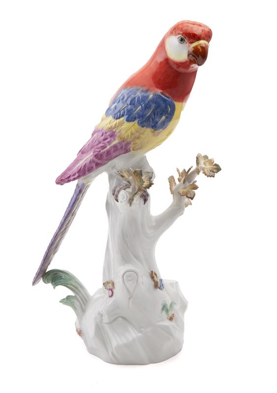 Meissen porcelain figure of a parrot perched: Meissen porcelain figure of a parrot perched, on a tree trunk with blue underglaze crossed sword mark. 13.25"H, Circa - 1900.
