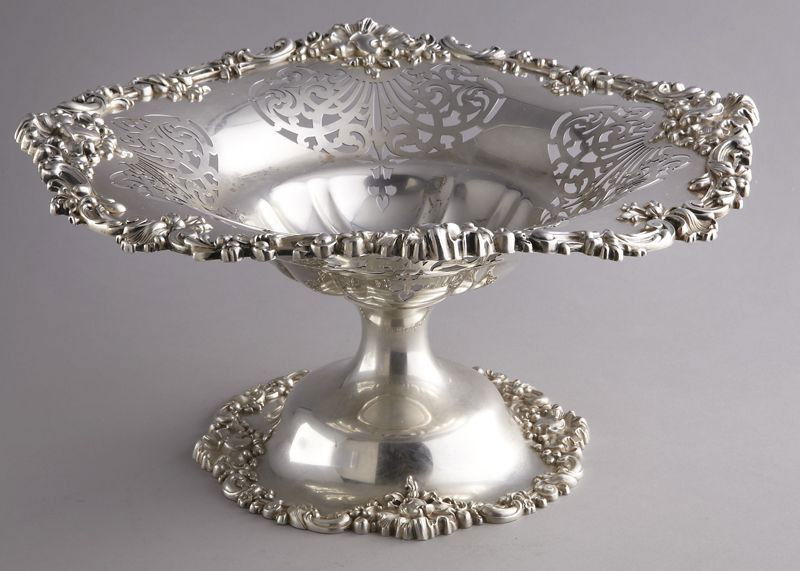 Large Berry and Whitmore Company pierced compote,: having a deep center, shaped rim and scroll cast border. Monogrammed, "G". Marked, "Berry and Whitmore Co., Sterling, 805E". 51.05 ozt. 7"H x 15.5" Dia., Circa - 20th C.