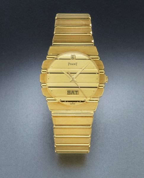 Men's 18K gold Piaget Polo watch,: with day and date aperture, quartz movement. Stamped, "Piaget quart 750 15562 c701 429291". 131.6 grams. Circa - Late 20th C.