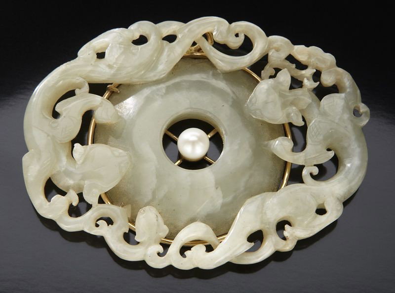 Chinese Ming jade bi disk surrounded by dragons,: with an Akoya pearl at the center. 2.75"H x 3.75"W, Circa - 17th C.