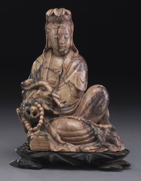 Chinese Qing carved soapstone Guanyin,: seated on a rock, holding a ruyi scepter. 7"H x 5.25"W, Circa - 18th - 19th C.